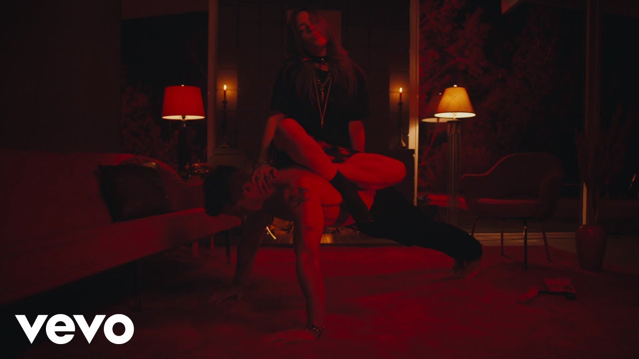 Billie Eilish performing at a concert, net worth 2026